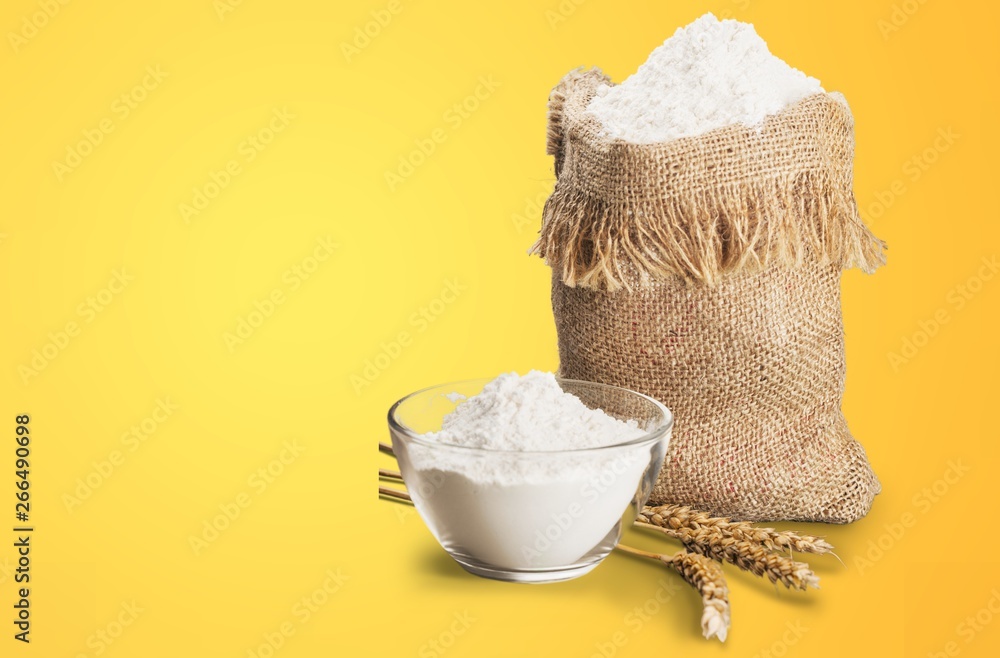 Wheat ears and flour on  background