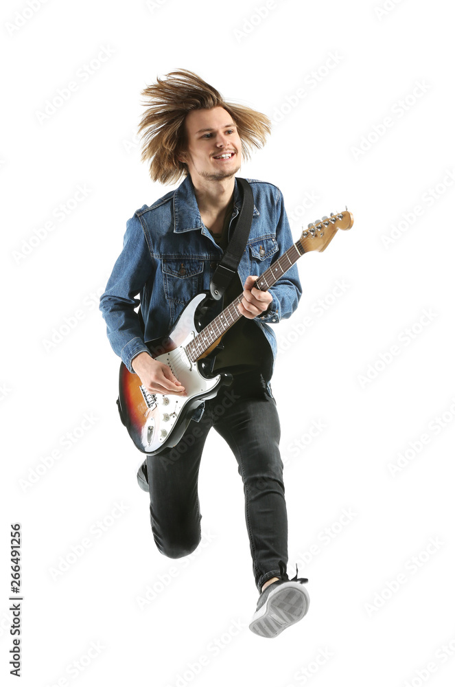 Jumping young man playing guitar on white background