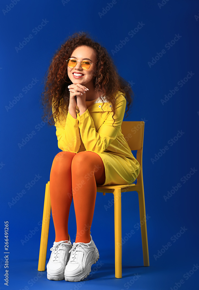 Beautiful young woman on color background