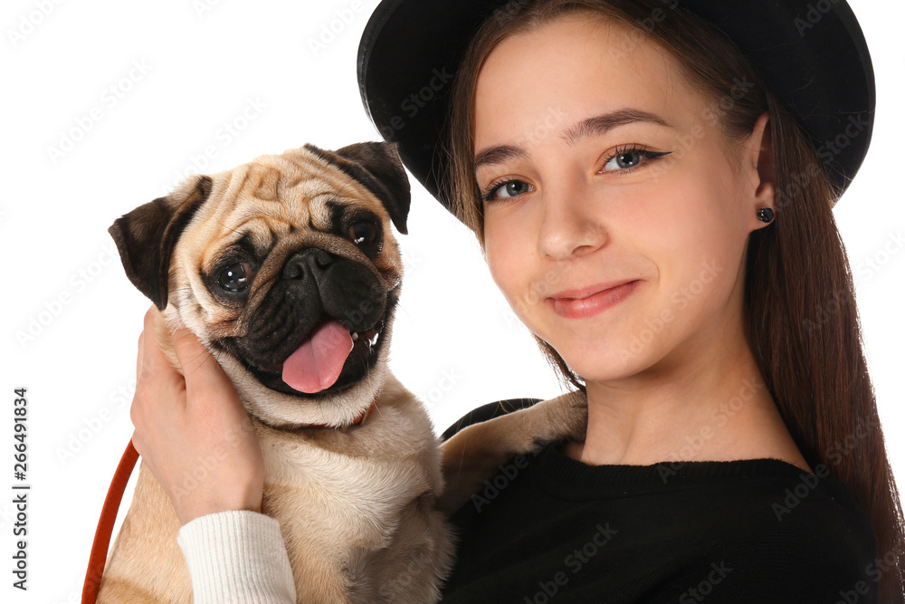 Teenage girl with cute pug dog on white background