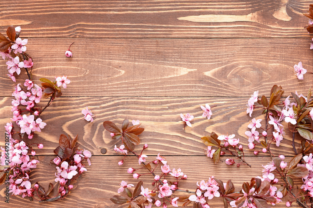 Beautiful blossoming branches on wooden background