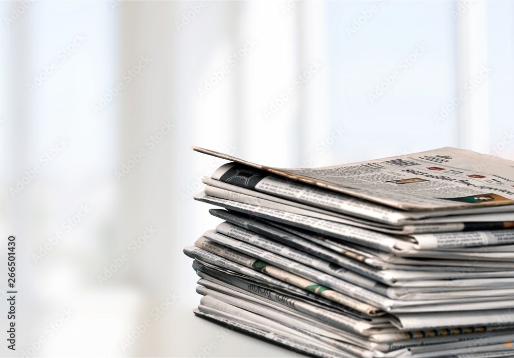 Pile of newspapers on white background