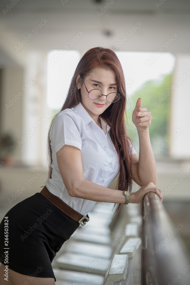 Beautiful Thai university student wearing Thai university student uniform.