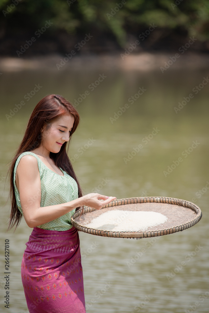 Portrait of beautiful young girl happy working after harvest agriculture in countryside village.