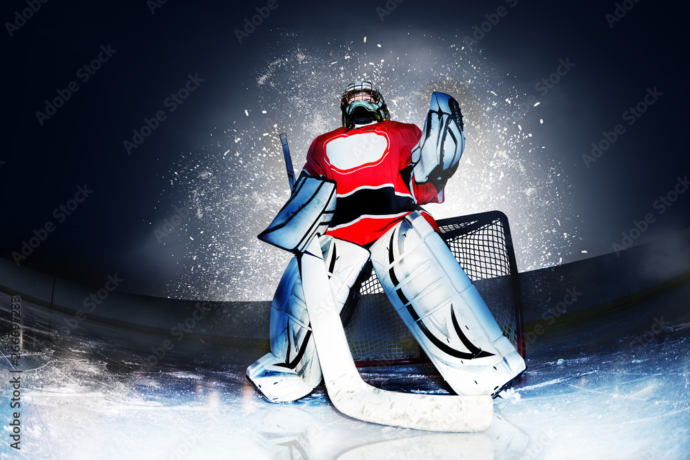 Goaltender at hockey arena in searchlight rays