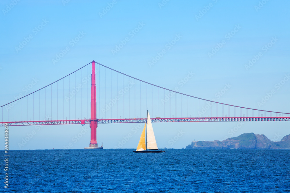 Sailboat passing under the Golden Gate Bridge, USA