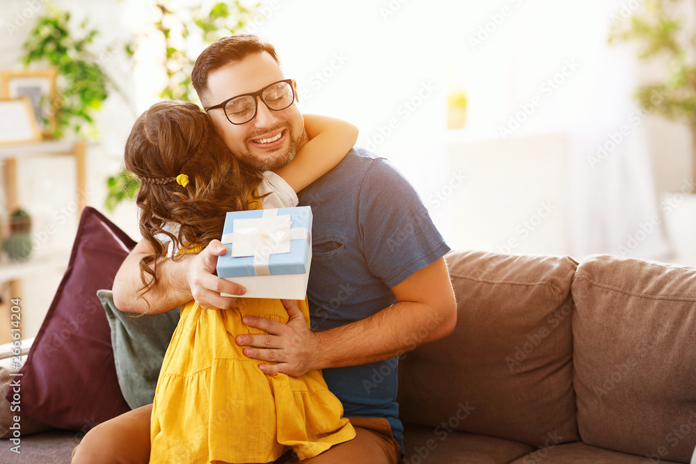 Fathers day. Happy family daughter hugging dad and laughs.