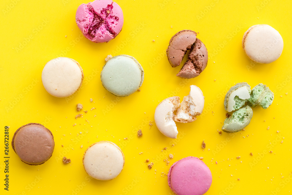 Macarons design on yellow background top view pattern