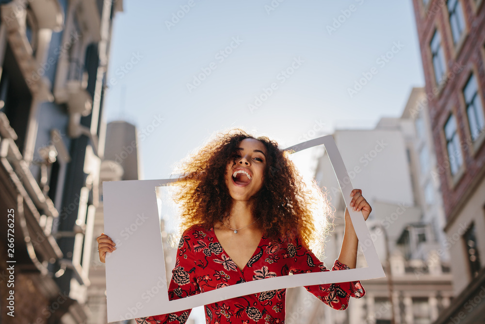 Excited girl with empty photo frame