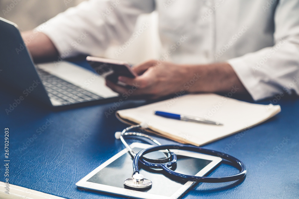 Doctor working in hospital office. Medical healthcare concept.