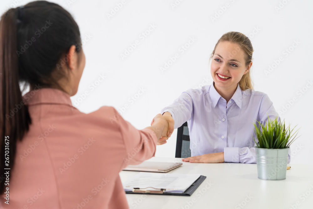 Two young business women in meeting at office table for job application and business agreement. Recr