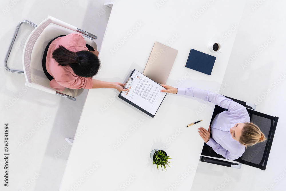 Two young business women in meeting at office table for job application and business agreement. Recr