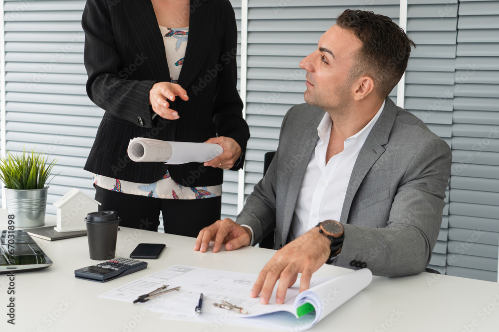 Businessman executive checking work while meeting discussion with businesswoman worker in modern wor