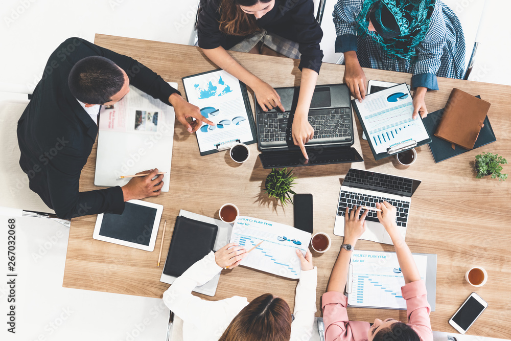 Top view of businessman executive in group meeting with other businessmen and businesswomen in moder