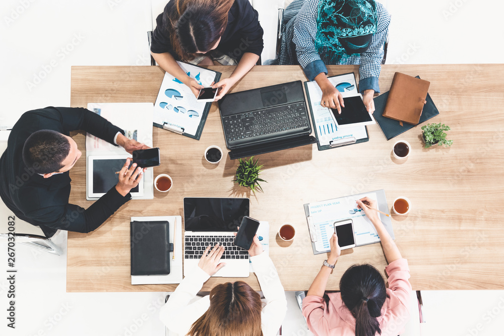 Top view of businessman executive in group meeting with other businessmen and businesswomen in moder