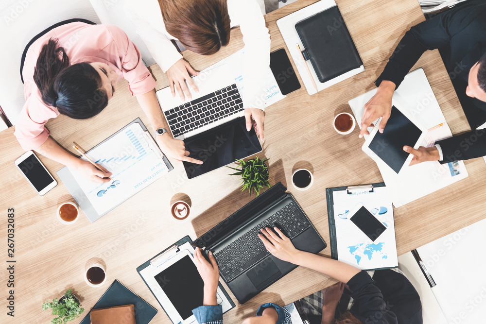 Top view of businessman executive in group meeting with other businessmen and businesswomen in moder