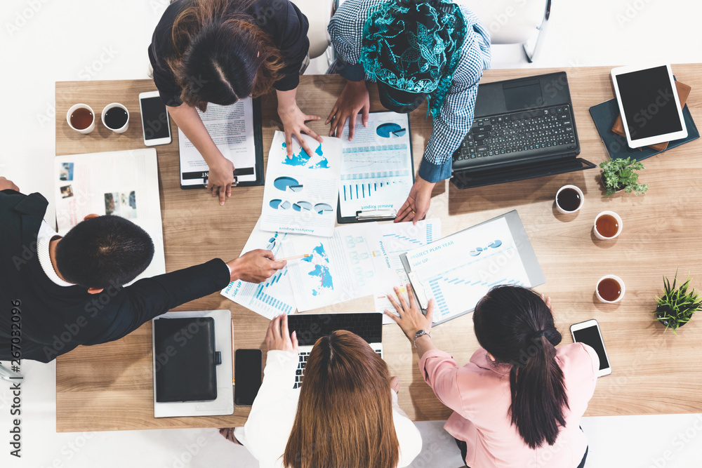 Top view of businessman executive in group meeting with other businessmen and businesswomen in moder