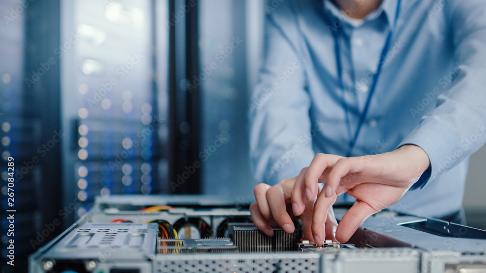 Close-up Shot in Modern Data Center: IT Engineer Installs New Hardware for Server Rack. IT Specialis