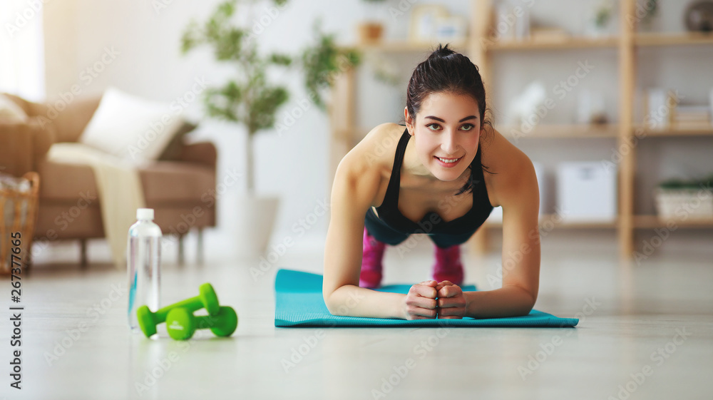 young woman doing fitness and sports at home