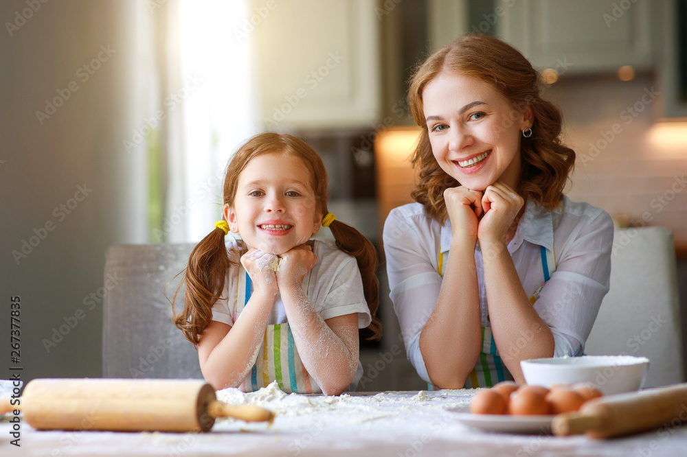 happy family in kitchen. mother and child baking cookies