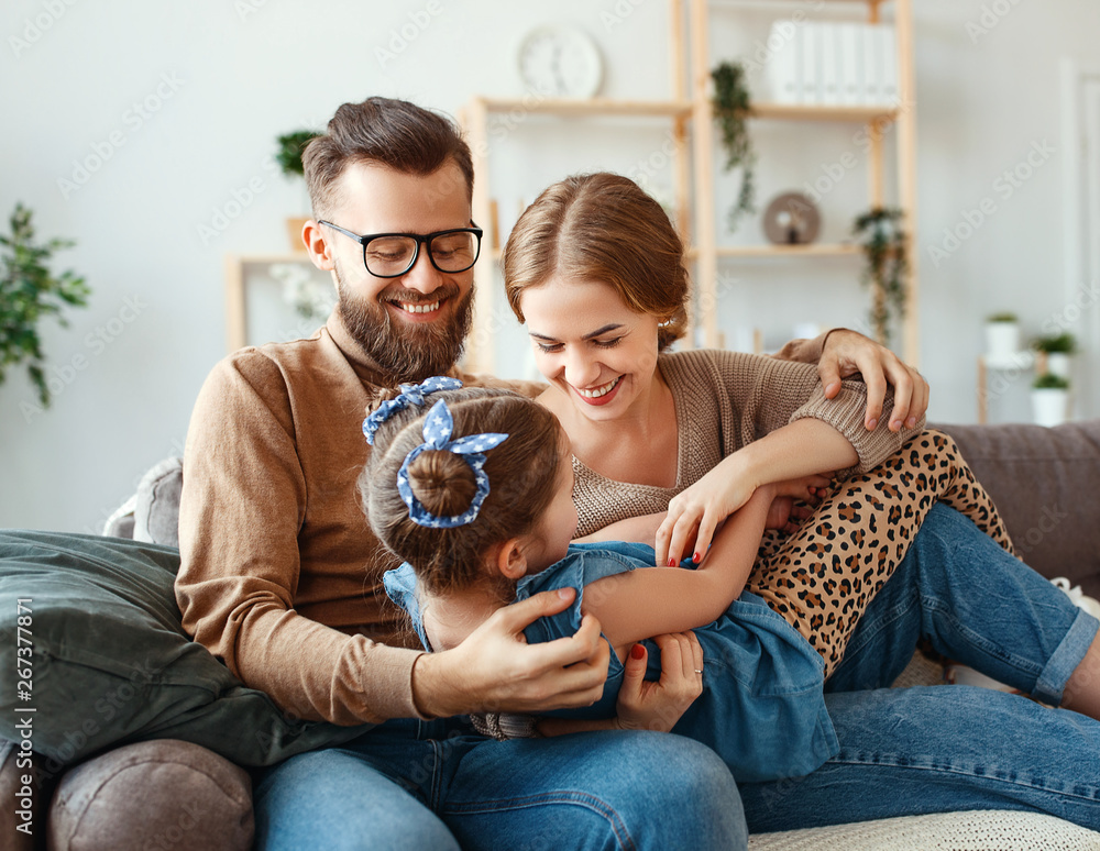 happy family mother father and child daughter laughing   at home  .