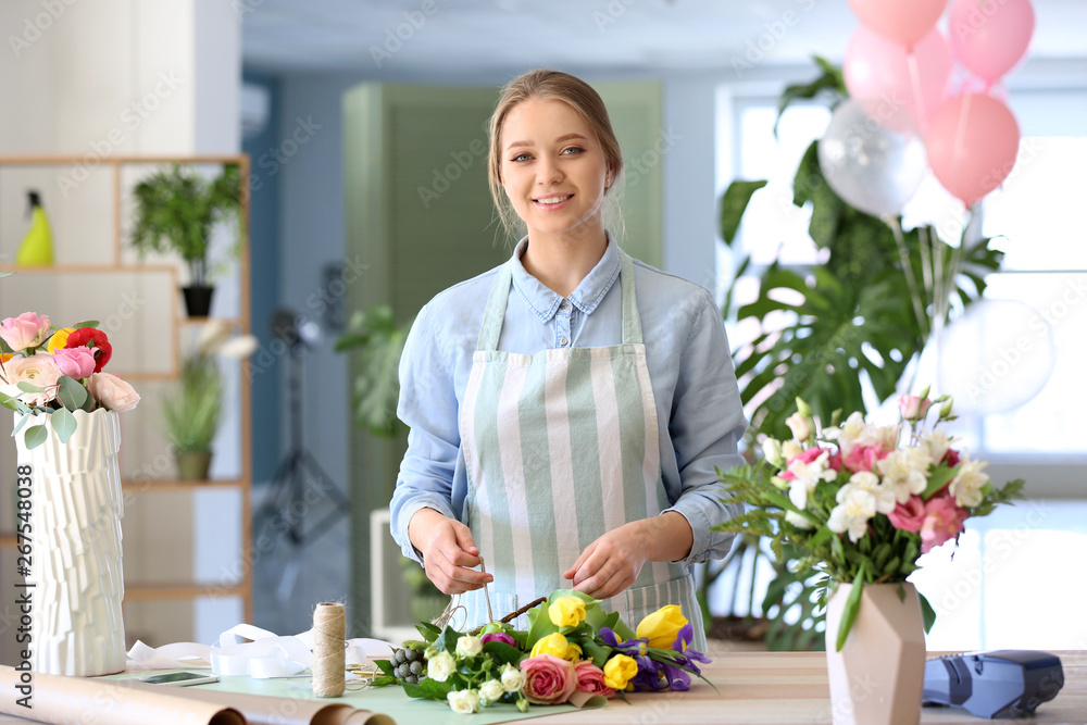 Florist making beautiful bouquet in shop