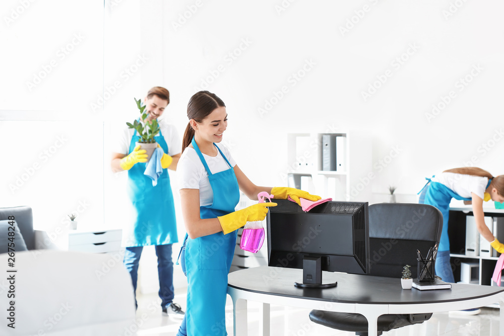 Team of janitors cleaning office