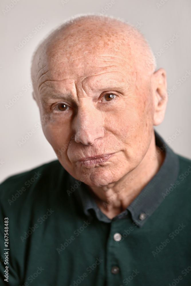 Portrait of senior man on grey background