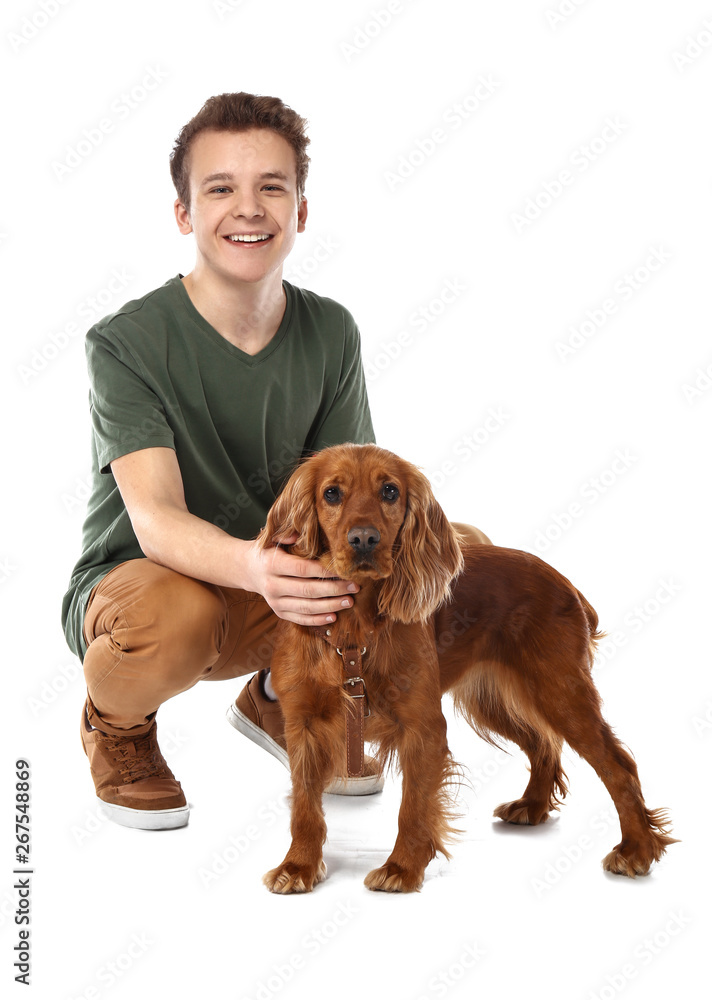 Teenage boy with cute dog on white background