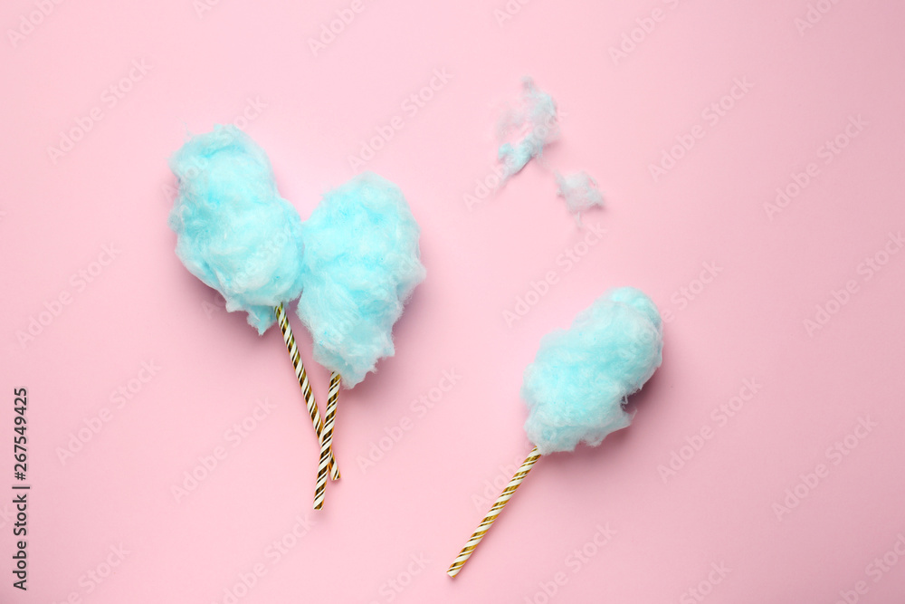 Tasty cotton candy on color background