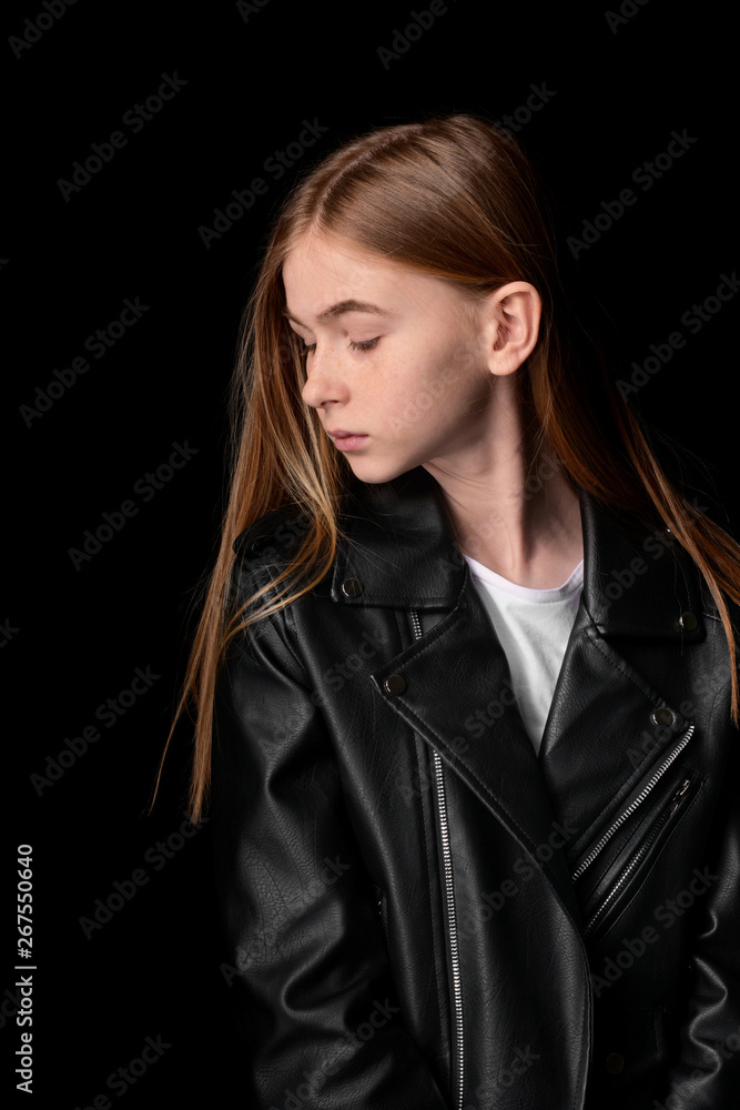 Sad teenage girl on dark background