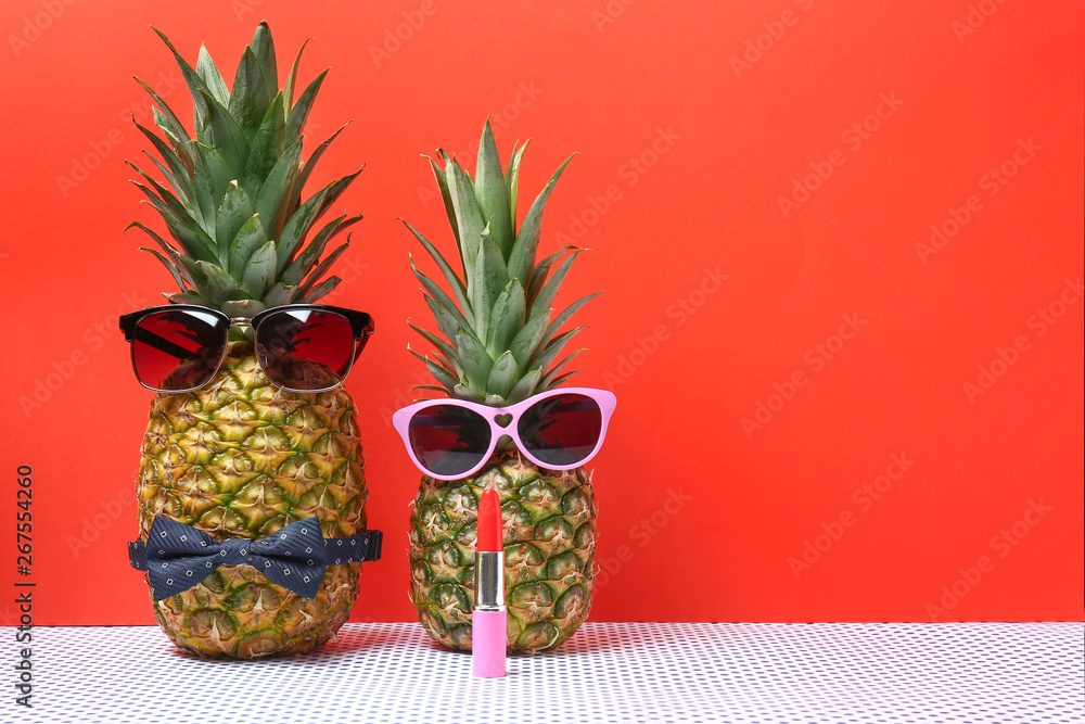 Creative composition with pineapples on color background