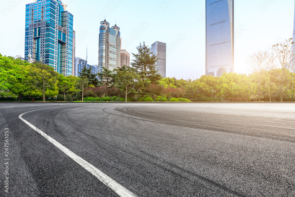 Asphalt race track and modern commercial office building in Shanghai