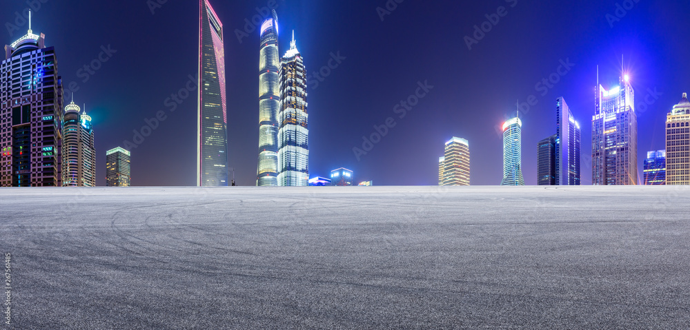 Asphalt race track and modern skyline and buildings in Shanghai at night,panoramic view