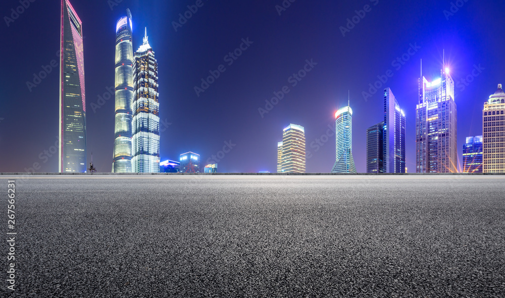 Shanghai modern commercial office buildings and empty asphalt highway at night