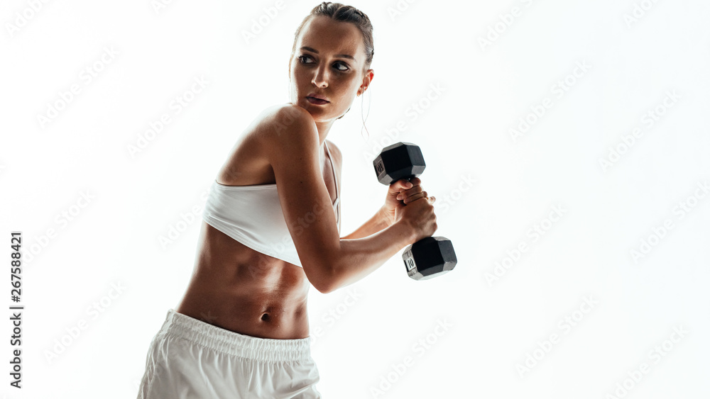 Tough woman doing workout with dumbbells