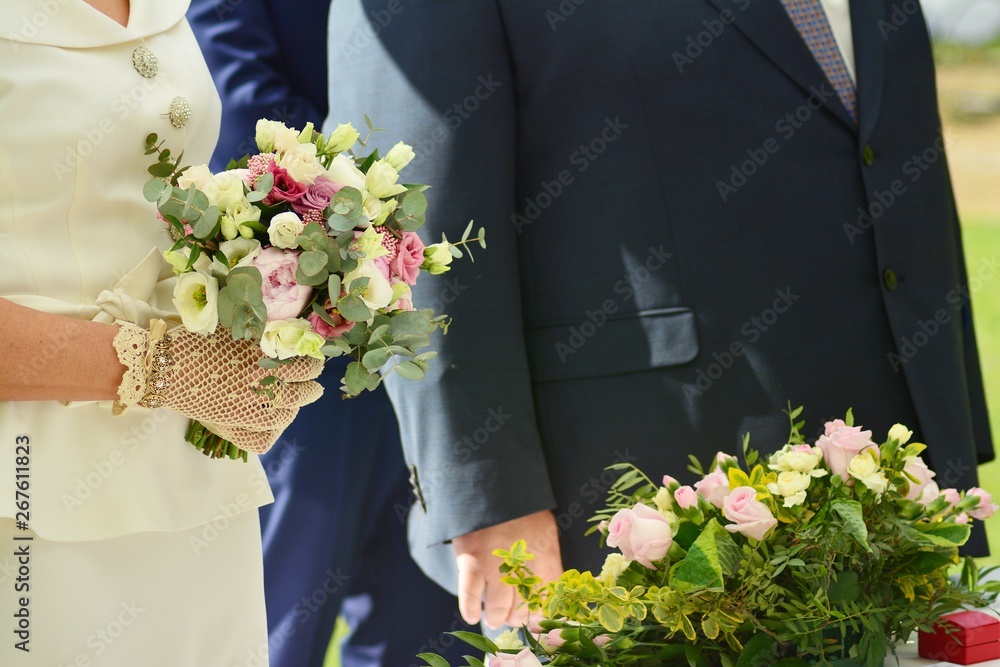 Couple holding stylish wedding bouquet 