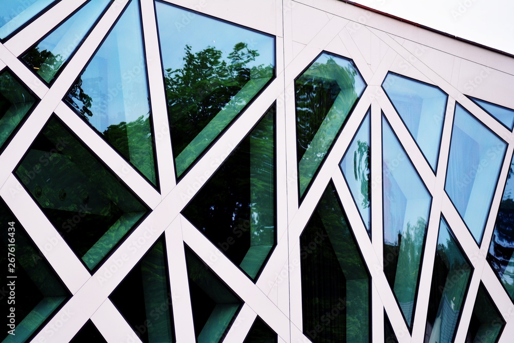 Abstract image of looking up at modern glass and concrete building. Architectural exterior detail of