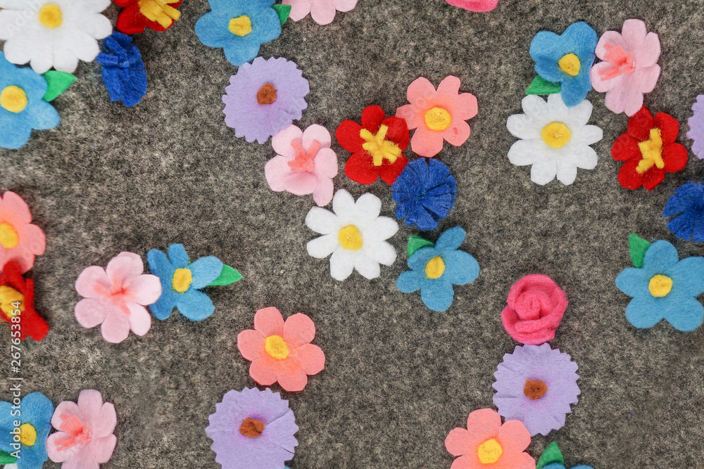 Felt colorful  flowers  over grey background