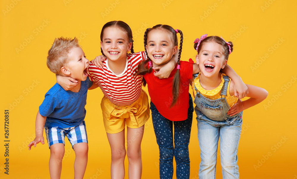 group of cheerful happy children on colored yellow background.