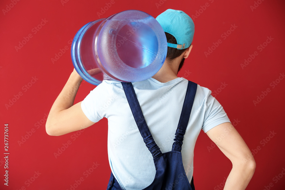 Delivery courier with bottle of water on color background, back view