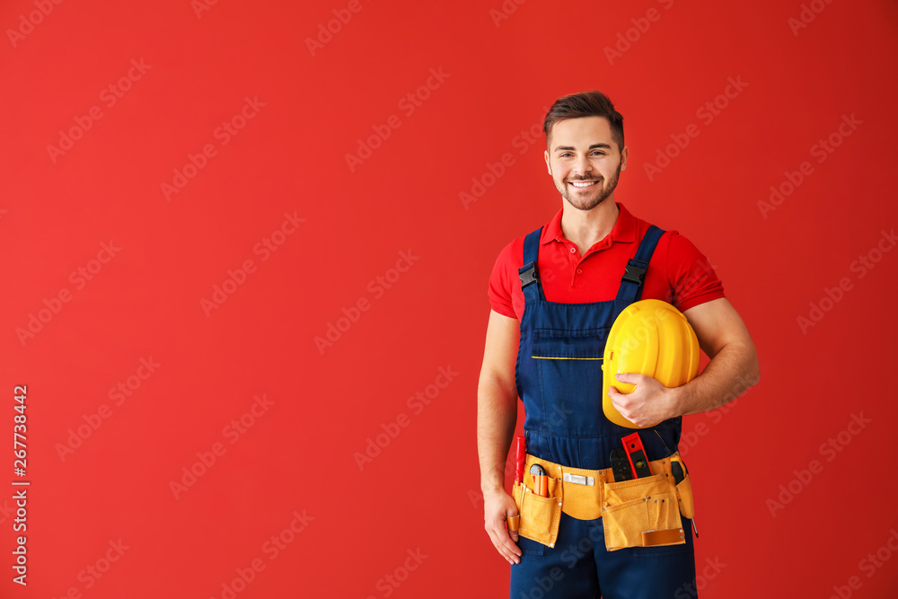 Male electrician on color background