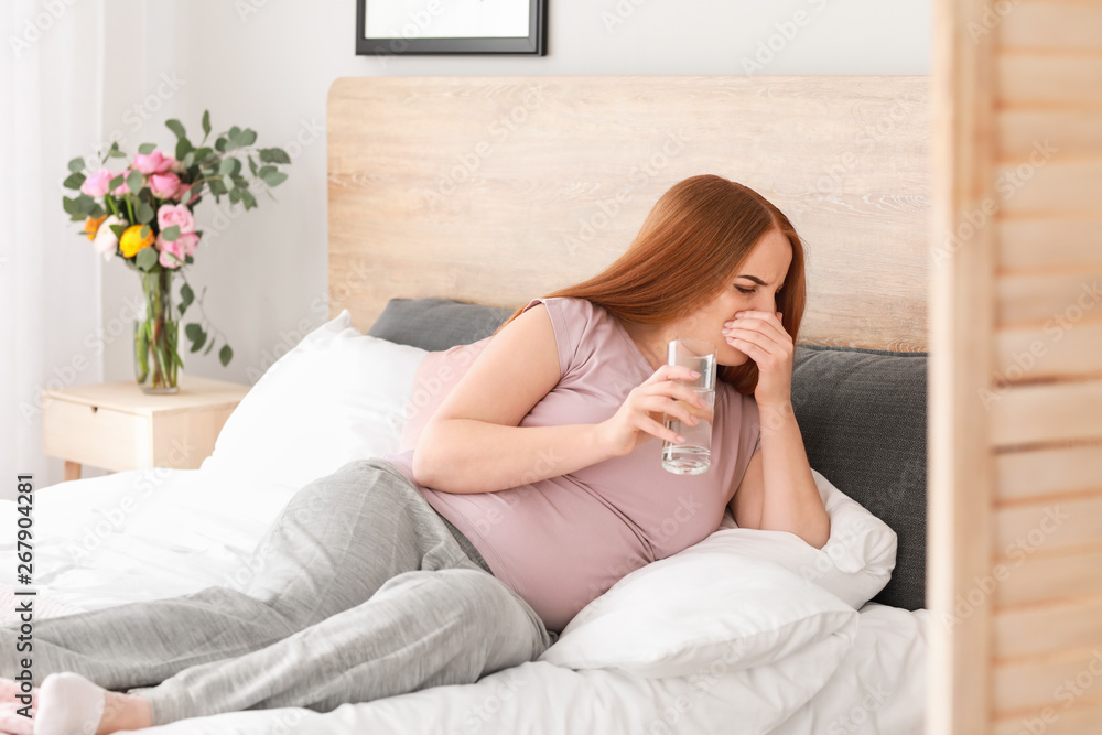 Young pregnant woman suffering from toxicosis at home