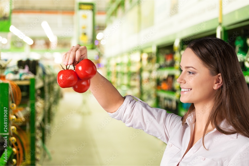 Woman with cart shopping in supermarket