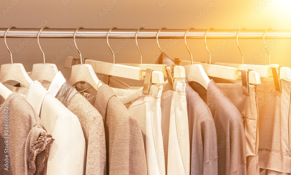 Modern clothes on metal hangers in closet