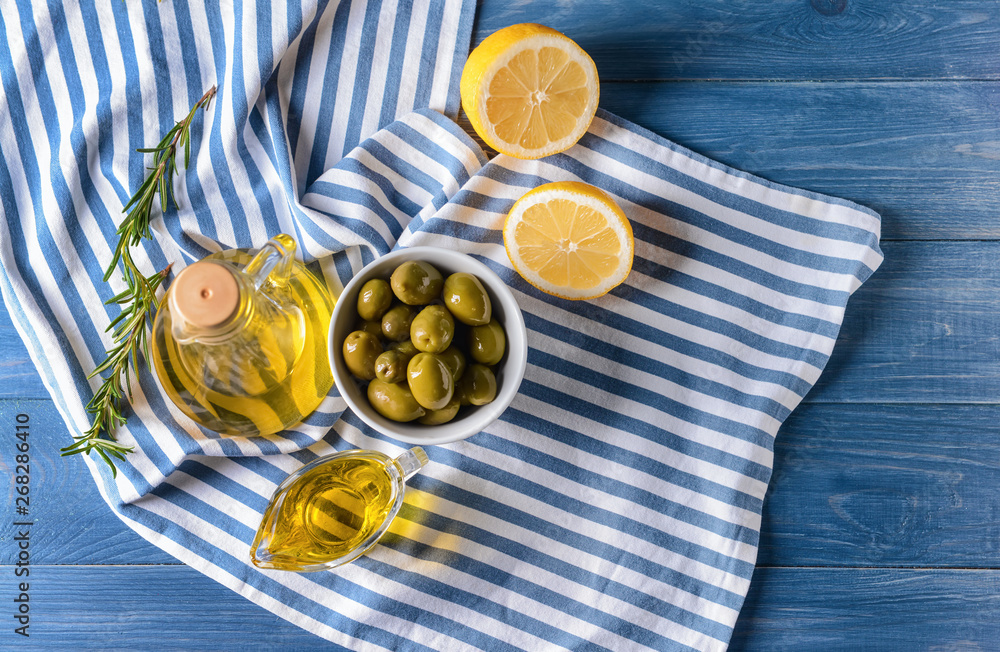 Tasty olive oil on wooden table