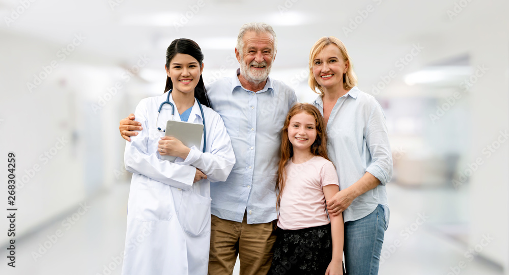 Doctor with happy family of mother, father and daughter at the hospital. Medical healthcare and doct