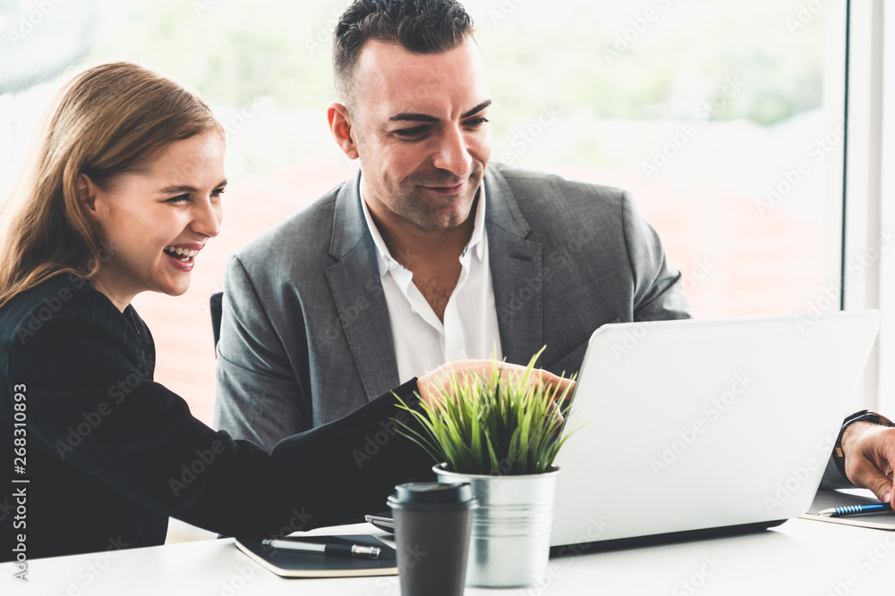 Businessman executive is in meeting discussion with a businesswoman worker in modern workplace offic