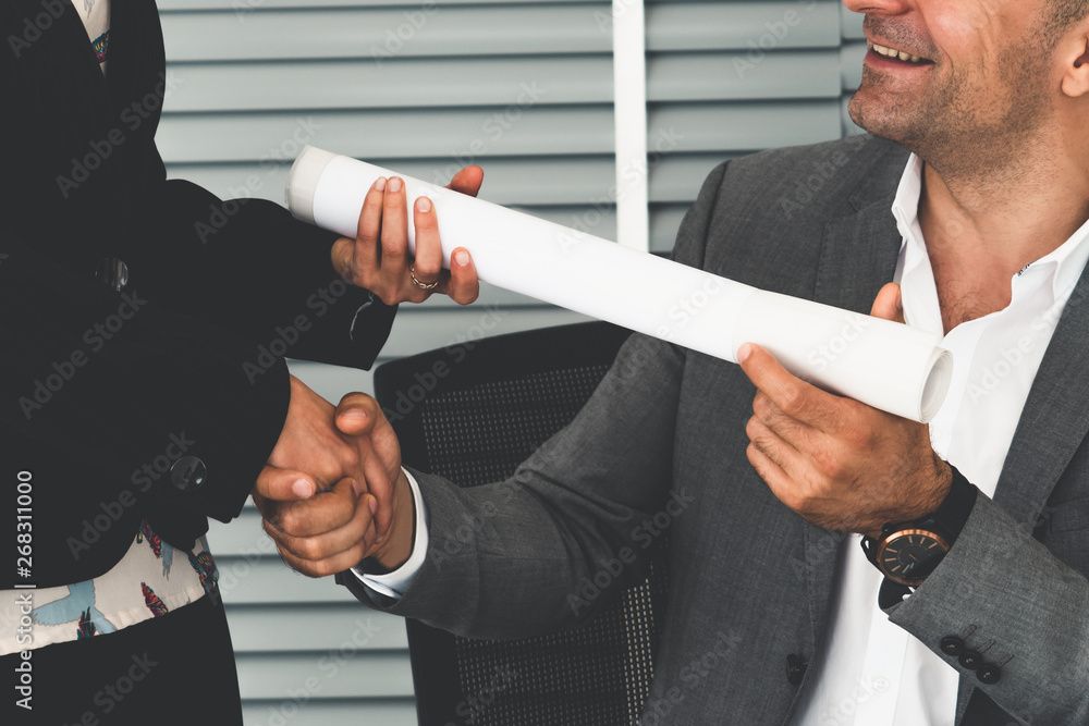 Businessman executive handshake with businesswoman worker in modern workplace office. People corpora