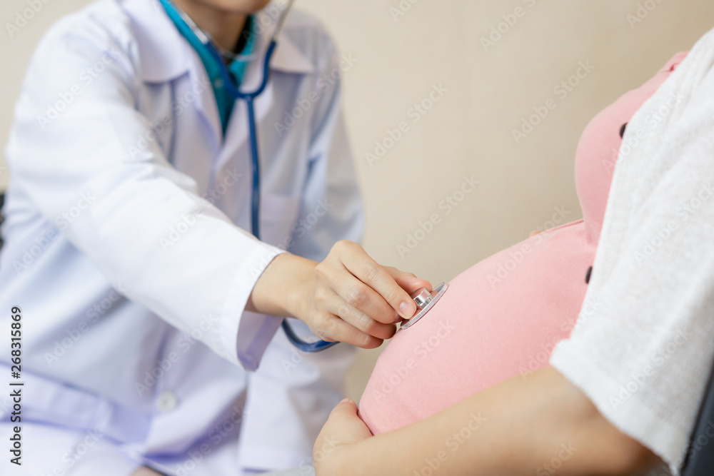 Happy pregnant woman visit gynecologist doctor at hospital or medical clinic for pregnancy consultan